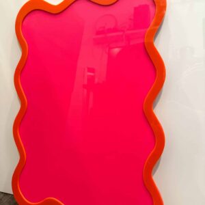 A custom, handcrafted, wave-shaped event board sign made from layered, multi-coloured, and frosted acrylic, with a border.