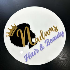 Custom round acrylic business sign for “Hair & Beauty” featuring layered gold, black, and lavender text with a crowned silhouette design.