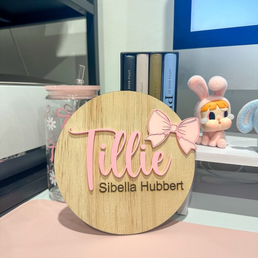 Acrylic baby announcement plaque with a bow theme, customised with a name and ready for personalisation.