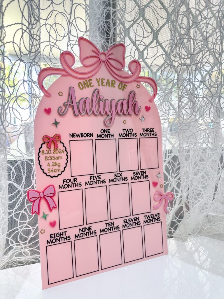 acrylic photo board with bow theme, personalised with a baby's name and birth details.