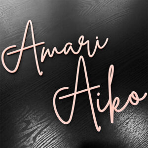 A baby pink acrylic name sign in a single-layer design, featuring names in pretty pink script lettering