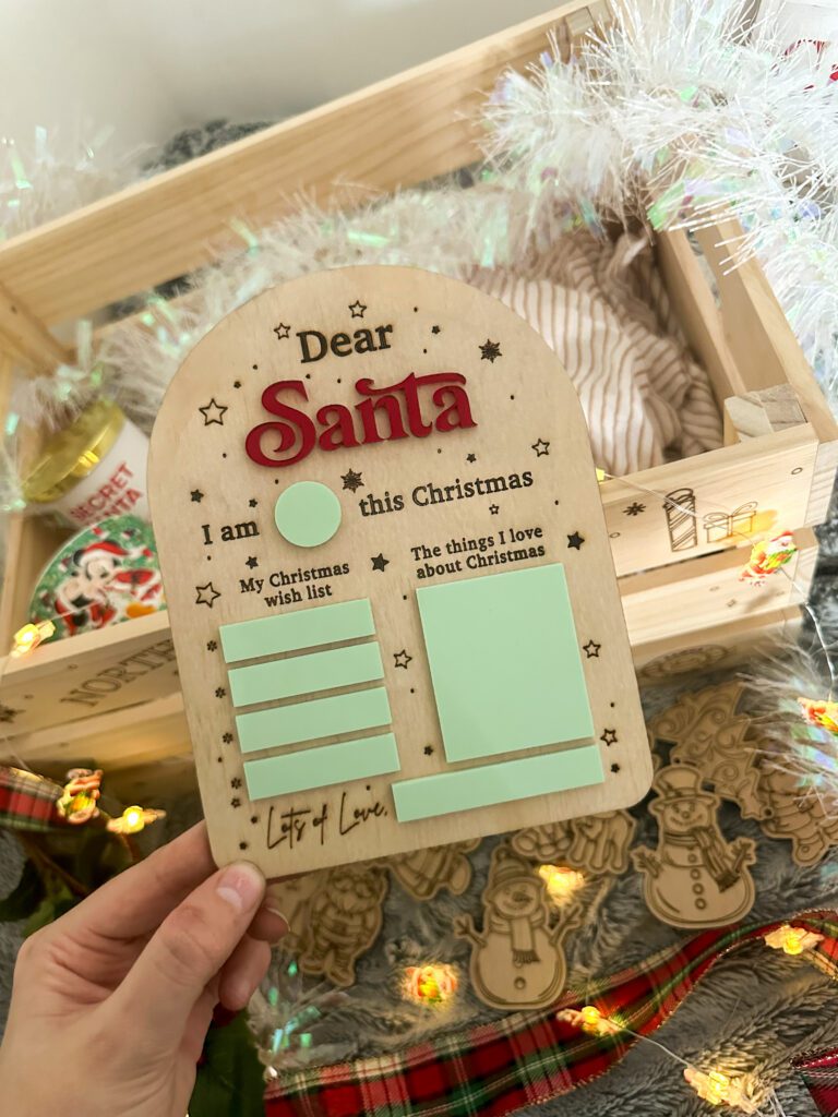 Wooden Santa wish list board for kids with sticky notes and Christmas decorations