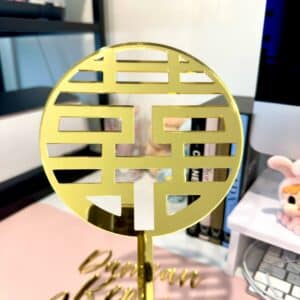 Personalised acrylic name sign photographed on a neutral background for home or event display.