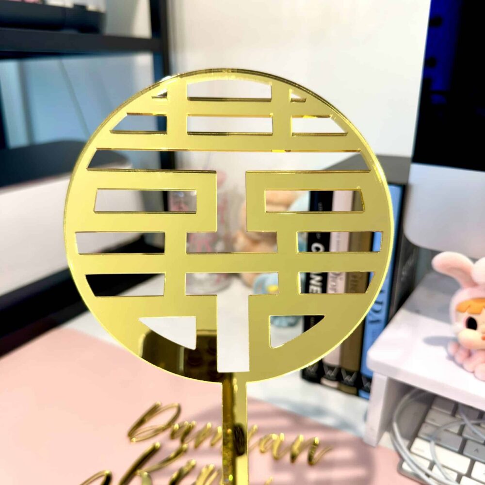 Personalised acrylic name sign photographed on a neutral background for home or event display.