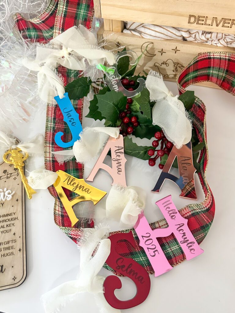 Acrylic letter ornaments with personalised engraved tags, available in various colours and finishes.