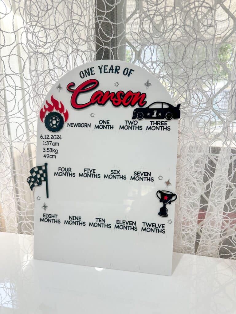 Personalised clear acrylic name sign with laser‑engraved lettering for wall display
