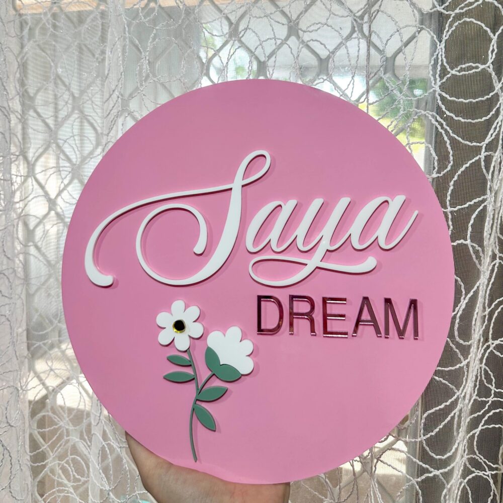 Personalised acrylic name sign for wall or shelf display.