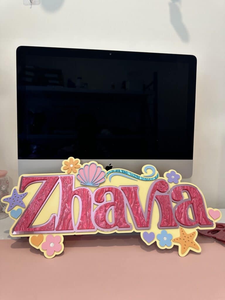 The product is a custom, handcrafted, and personalised bedroom name plaque made of layered acrylic, with a mermaid design.