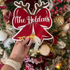 Personalised acrylic name sign with laser-engraved lettering on clear acrylic.