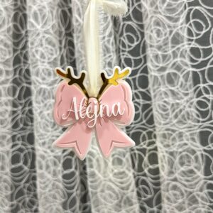 A custom, handcrafted, layered acrylic bow Christmas ornament, ready for personalisation. Personalised with a name, this.