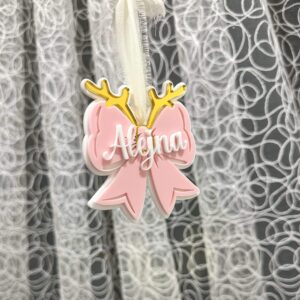 A custom, handcrafted, layered acrylic bow Christmas ornament, personalised with a name, ready for personalisation.