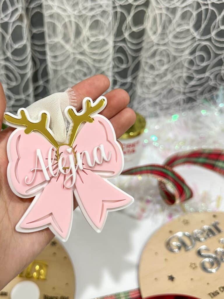 A custom, personalised, layered acrylic bow Christmas ornament, ready for personalisation.