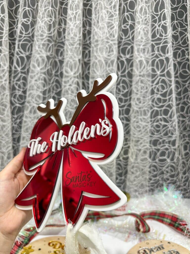 Personalised Christmas Bow Door Hanger – Santa’s Key, made from layered, mirrored finish, acrylic.