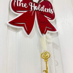 Personalised Christmas Bow Door Hanger – Santa’s Key, made from layered acrylic with a mirrored finish.