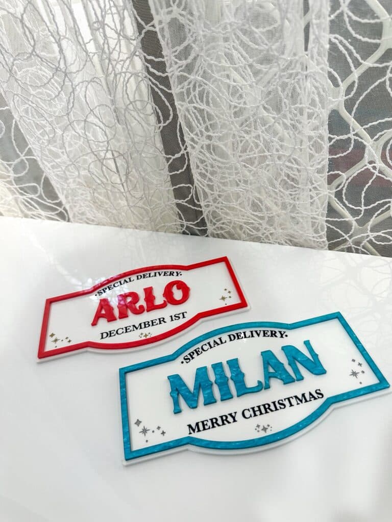Personalised acrylic name plaque with laser-engraved lettering on a clear panel.