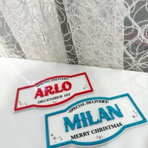 Personalised acrylic name plaque with laser-engraved lettering on a clear panel.