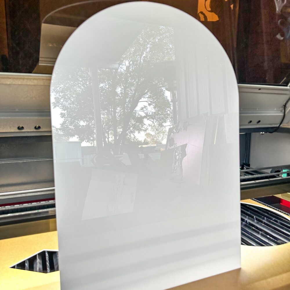 Personalised acrylic name sign photographed on a neutral background.