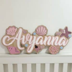 Personalised clear acrylic name sign with laser-engraved lettering.