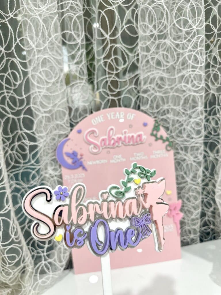 acrylic photo board featuring a fairy garden scene, personalised with the baby's name and first year details.