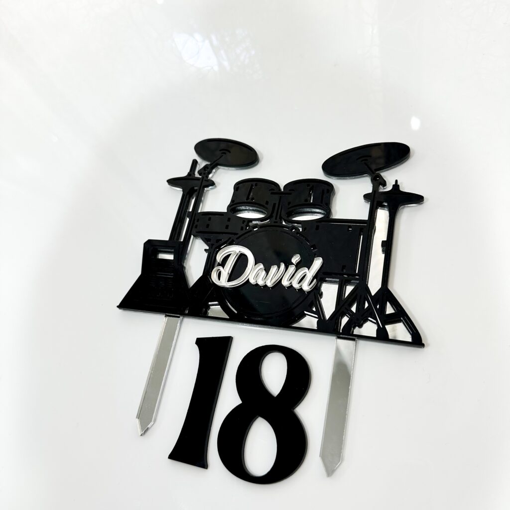 Personalised acrylic name sign with laser-engraved lettering on a neutral background.