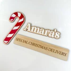 Laser-engraved personalised acrylic name sign on plain background.