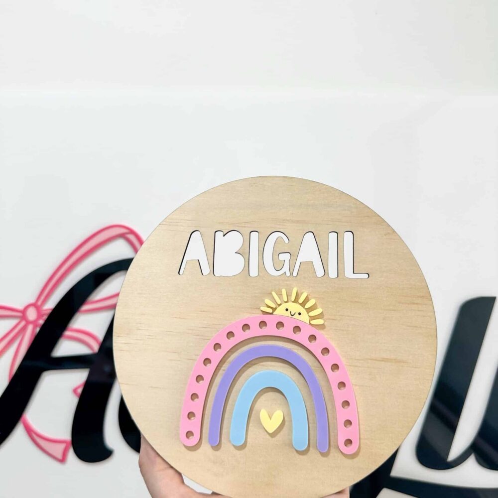 Personalised acrylic name sign photographed on a neutral background.