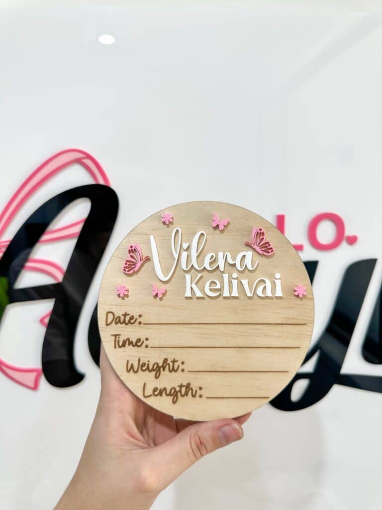 A personalised acrylic name sign with script lettering.