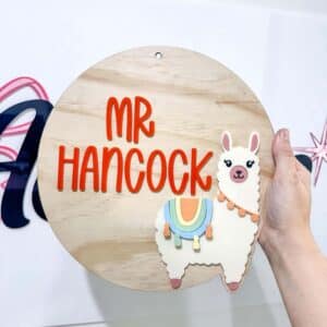 Personalised acrylic name plaque showing customised text on a clear panel