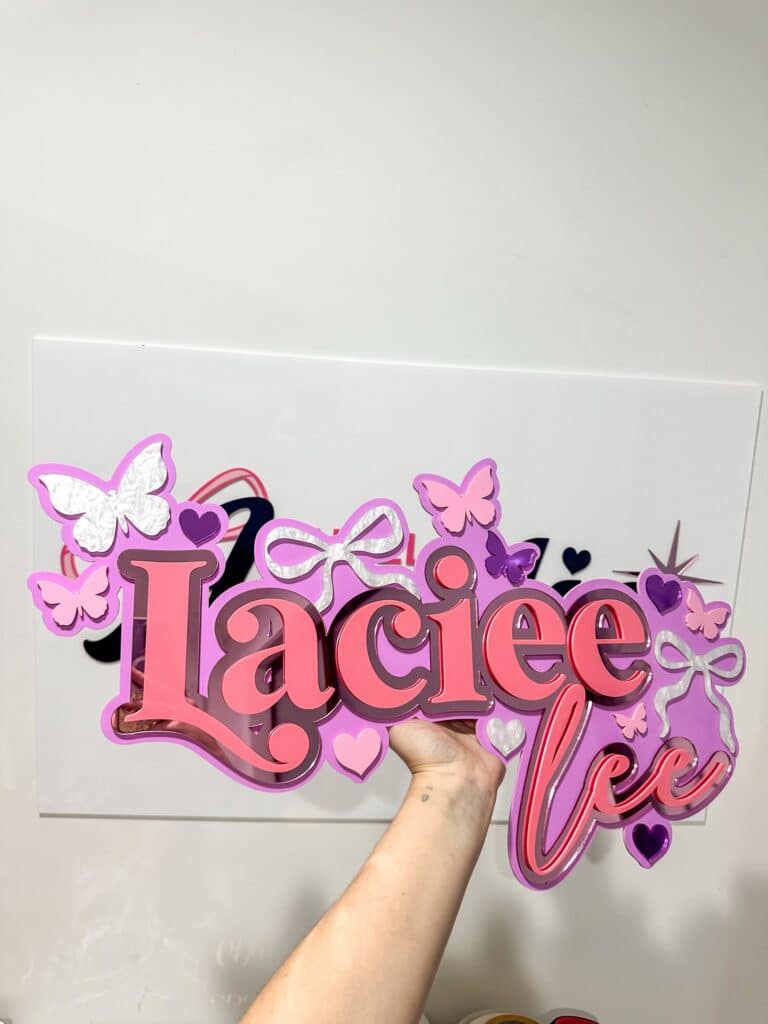 Personalised acrylic name wall sign on a plain background