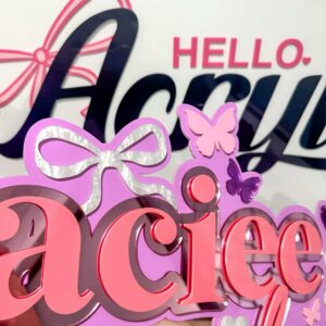 Clear personalised acrylic name plaque with engraved lettering on a neutral background.