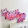 Personalized Butterfly Name Sign - Laciee Purple Pink Nursery Decor with Colorful Butterflies Purple and pink personalized name sign reading "Laciee" with colorful butterfly decorations, hearts, and gradient text displayed on white shelf against white wall