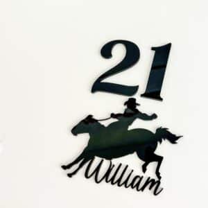 Personalised acrylic name sign in script lettering on a neutral background.