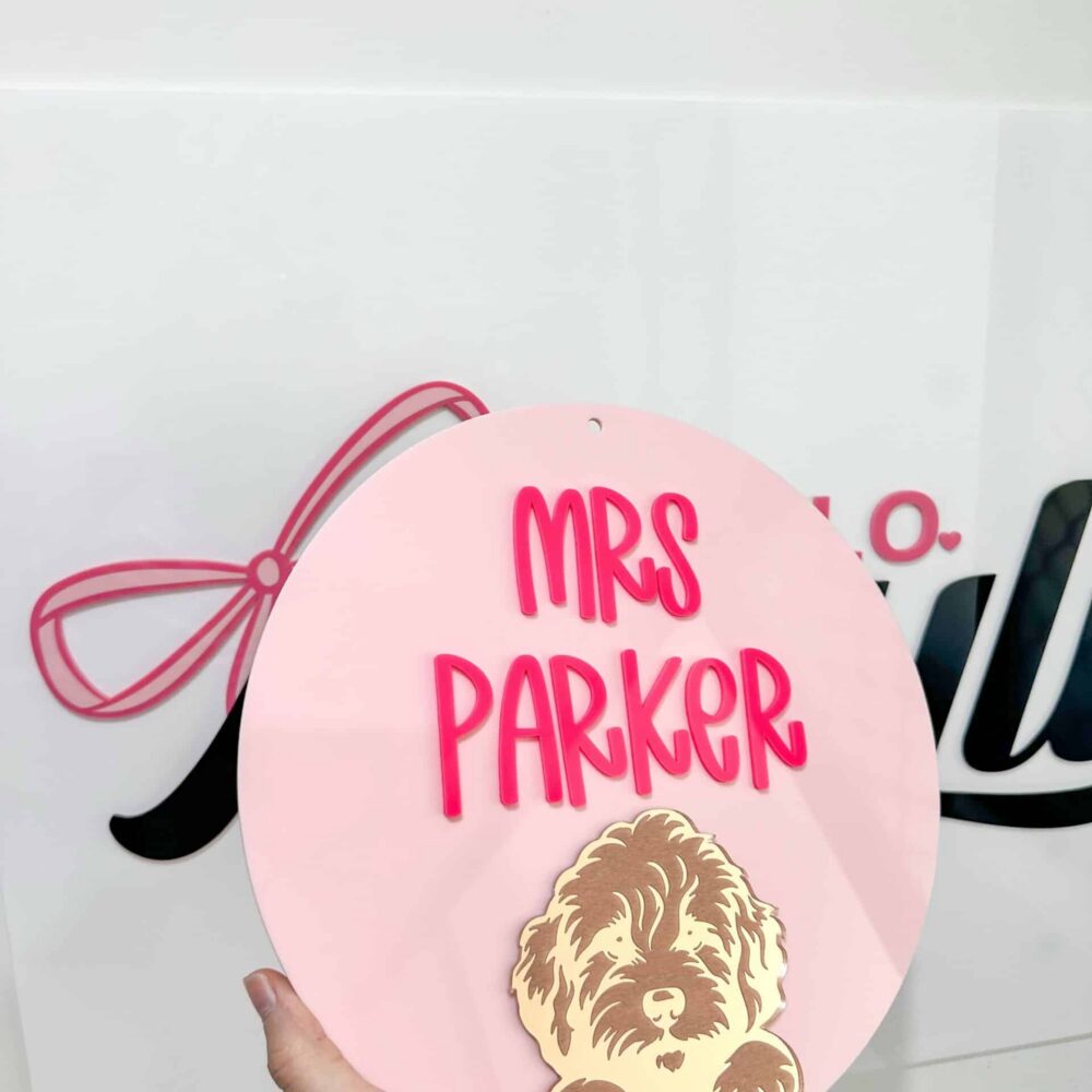 Personalised acrylic name sign on a plain background.