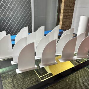 Personalised acrylic name sign on a plain background with crisp, slim lettering.
