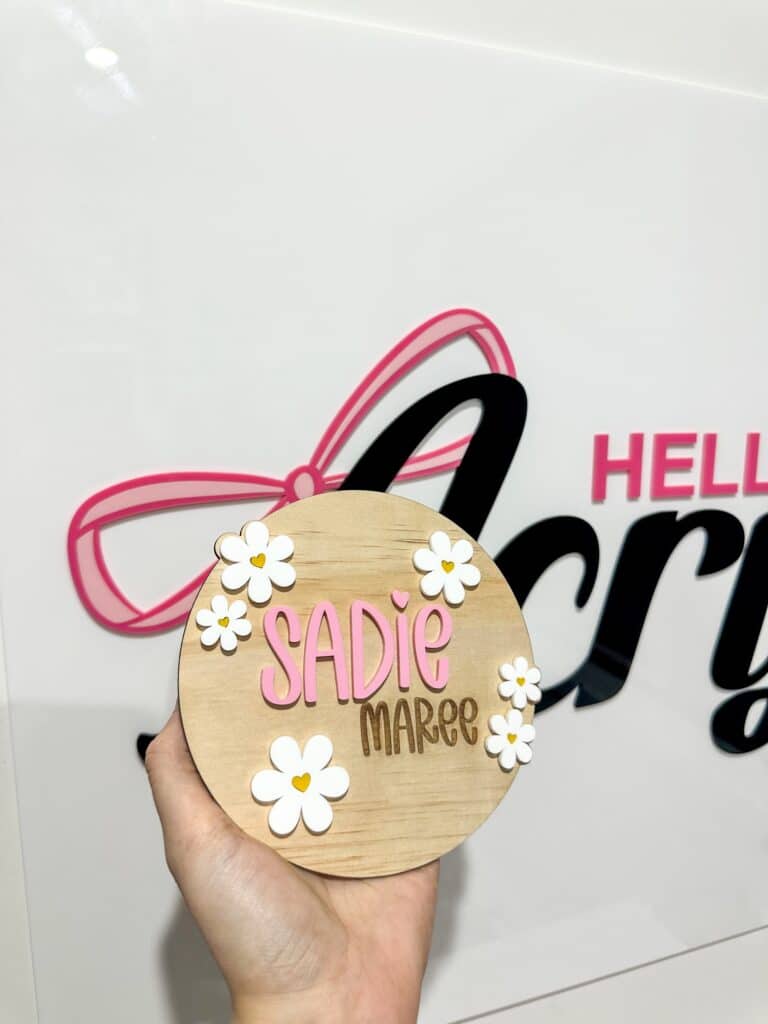 Personalised acrylic name plaque with laser-engraved lettering on clear acrylic.