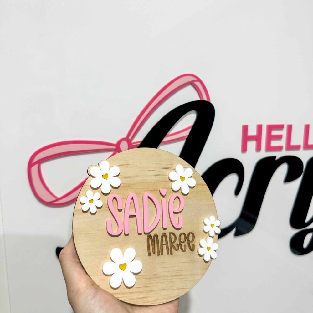 Personalised acrylic name plaque with laser-engraved lettering on clear acrylic.