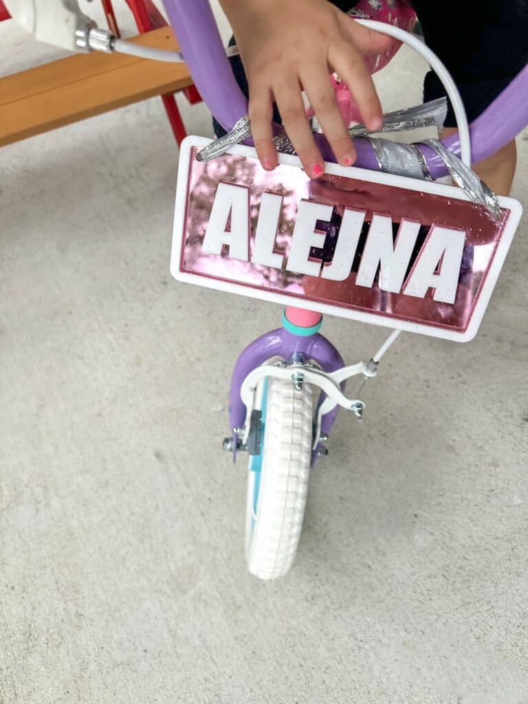 layered acrylic name plate with a mirrored finish, custom ride-on name plate for kids vehicles.