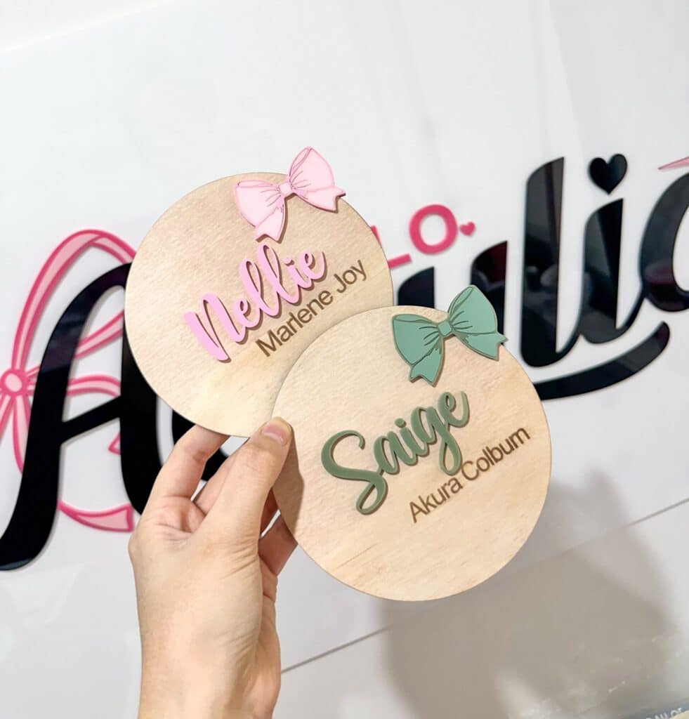 engraved wood with acrylic detailing, personalised baby announcement plaque bow theme.