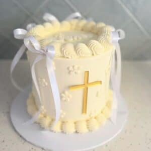 acrylic cross cake charm for baptism and communion, frosted with a satin finish.