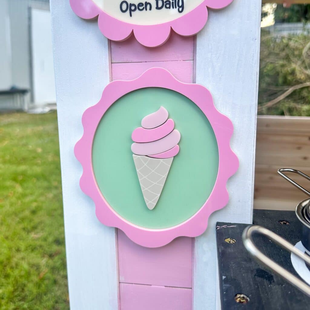 acrylic scallop kids wall sign with a layered acrylic ice cream cone design, personalised with a name in a bold font.