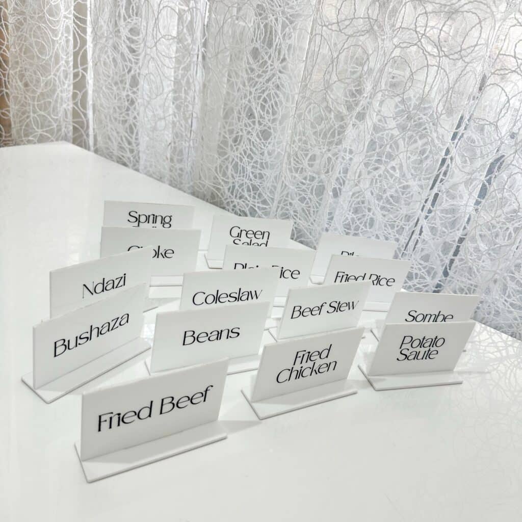 Acrylic food labels, custom catering signs, made from layered acrylic, with a glossy finish, for labelling dishes at events.