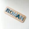 A custom, handcrafted, wooden and layered acrylic name puzzle for kids, featuring a personalisation option for a special.